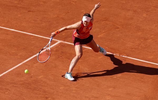 France's Alize Cornet plays a backhand return to Italy's Camila Giorgi during their women's singles match on day one of the Roland-Garros Open tennis tournament at the Court Philippe-Chatrier in Paris