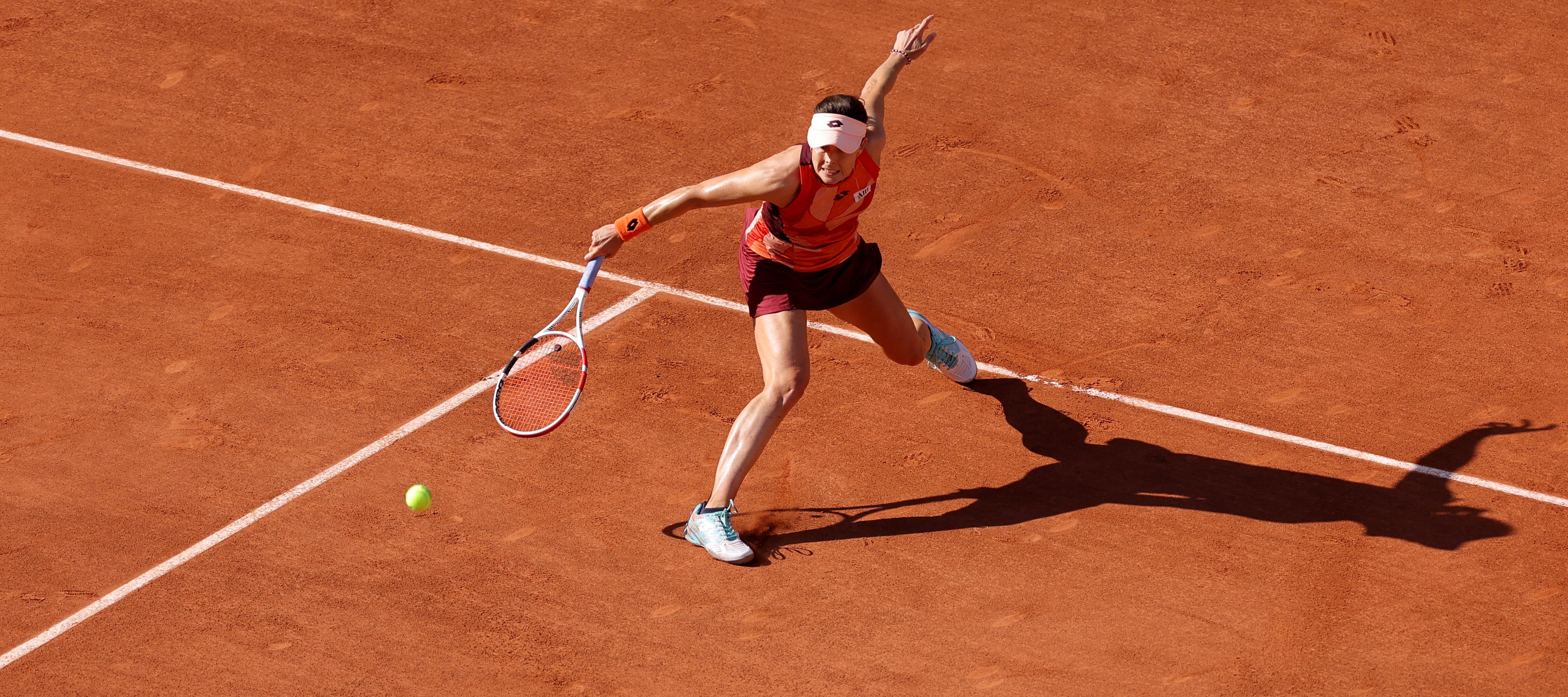 France's Alize Cornet plays a backhand return to Italy's Camila Giorgi during their women's singles match on day one of the Roland-Garros Open tennis tournament at the Court Philippe-Chatrier in Paris